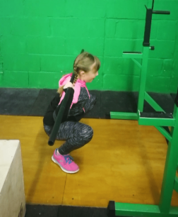 Pride Performance Warrington child Member practicing her squat technique